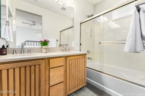 a bathroom with a double vanity sink and a mirror