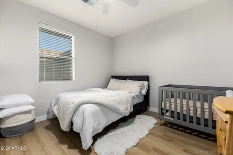 a bed sitting in a bedroom next to a window