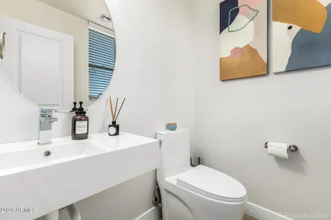 a bathroom with a sink mirror and toilet