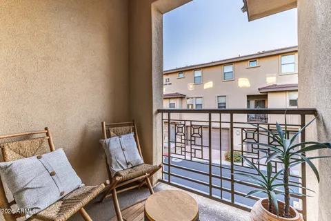 a view of a hallway with furniture and a floor to ceiling window