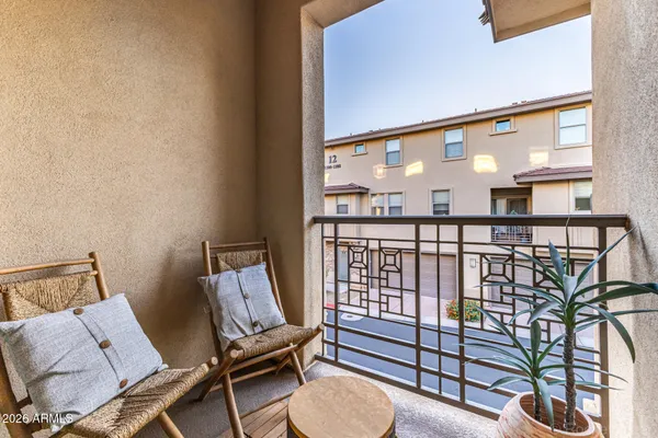 a view of a hallway with furniture and a floor to ceiling window