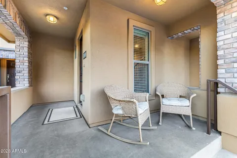 a balcony with table and chairs