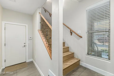 a view of staircase with wooden floor and a window