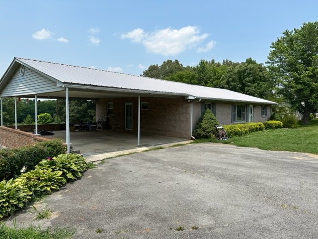 3950 Viola Road McMinnville, TN 37110 - Photo 1 of 26 a view of a house with a yard and potted plants