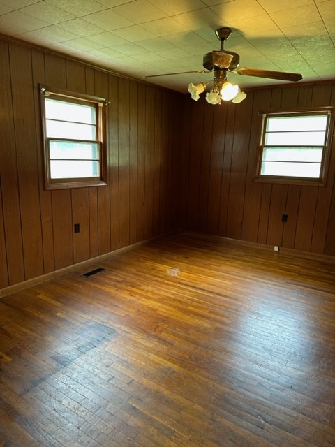 3950 Viola Road McMinnville, TN 37110 - Photo 21 of 26 an empty room with wooden floor chandelier fan and windows
