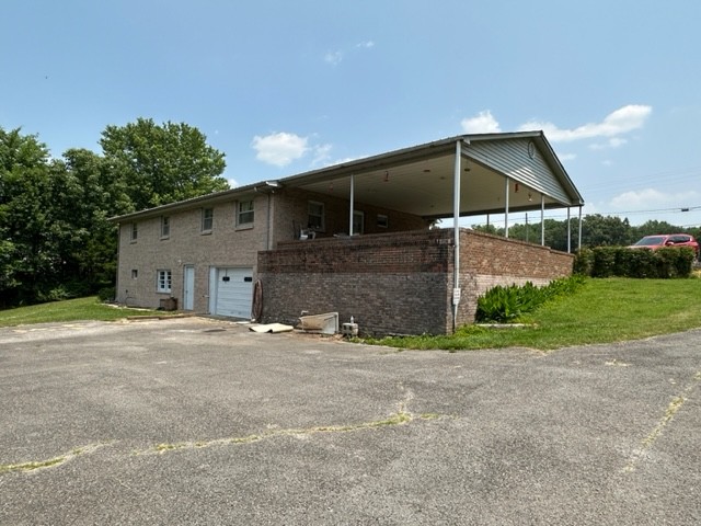 3950 Viola Road McMinnville, TN 37110 - Photo 4 of 26 a front view of a house with a yard and garage