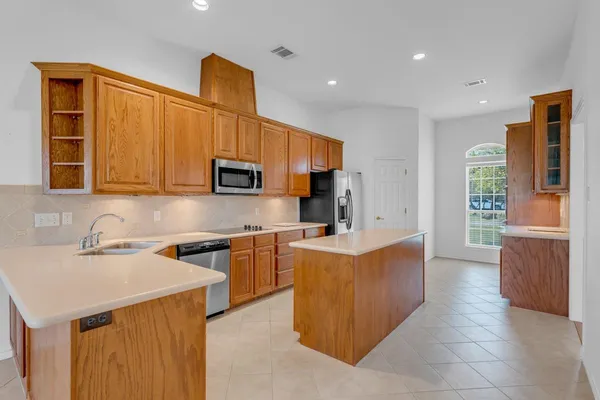 a kitchen with stainless steel appliances granite countertop a sink stove and refrigerator