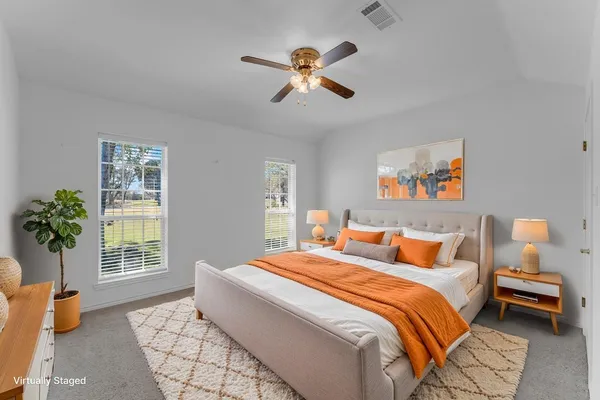 a bedroom with a bed and window