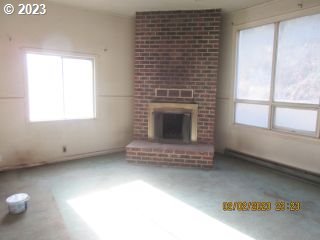 15030 Northwest Cornelius Pass Road Portland, OR 97231 - Photo 3 of 16 a view of an empty room with a fireplace and a window