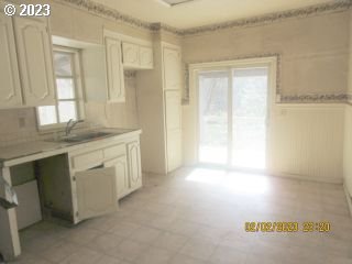 15030 Northwest Cornelius Pass Road Portland, OR 97231 - Photo 4 of 16 a view of a kitchen with a sink and dishwasher