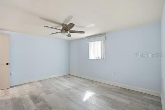 12612 4th Isle Hudson, FL 34667 - Photo 14 of 50 wooden floor in an empty room with a window