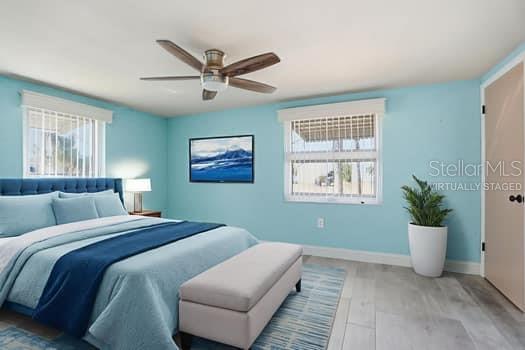 12612 4th Isle Hudson, FL 34667 - Photo 17 of 50 a bedroom with a large bed and a potted plant