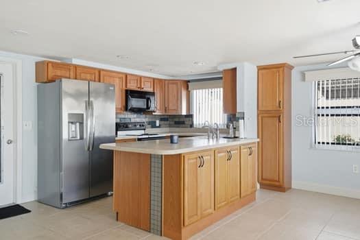 12612 4th Isle Hudson, FL 34667 - Photo 20 of 50 a kitchen with stainless steel appliances granite countertop a refrigerator and a stove top oven