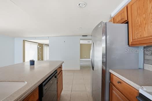 12612 4th Isle Hudson, FL 34667 - Photo 24 of 50 a kitchen with stainless steel appliances granite countertop a sink and a refrigerator