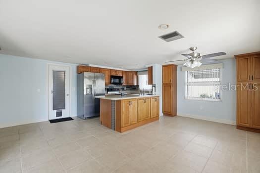 12612 4th Isle Hudson, FL 34667 - Photo 25 of 50 a view of a kitchen with refrigerator and window
