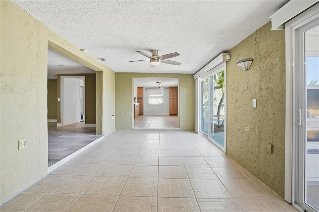 12612 4th Isle Hudson, FL 34667 - Photo 33 of 50 a view of a hallway with a chandelier fan and windows