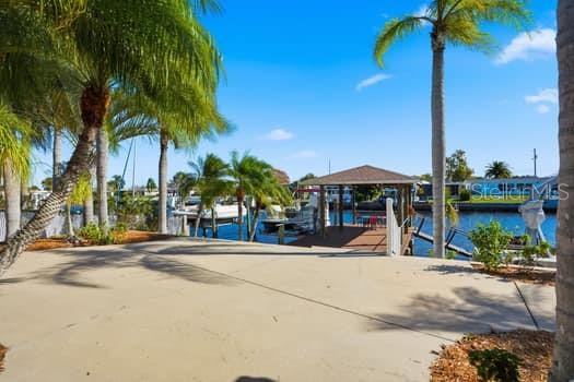 12612 4th Isle Hudson, FL 34667 - Photo 8 of 50 a view of a street with a building and palm trees