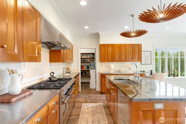 a kitchen with stainless steel appliances granite countertop a sink stove and refrigerator