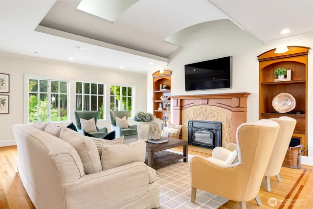 a living room with furniture a fireplace and a flat screen tv