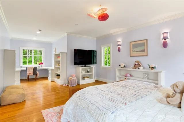 a bedroom with a bed and a flat screen tv