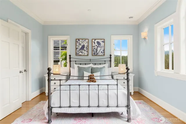 a bedroom with furniture and a large window