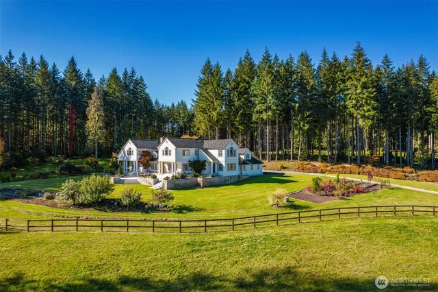a view of a swimming pool with an outdoor seating and house in the background