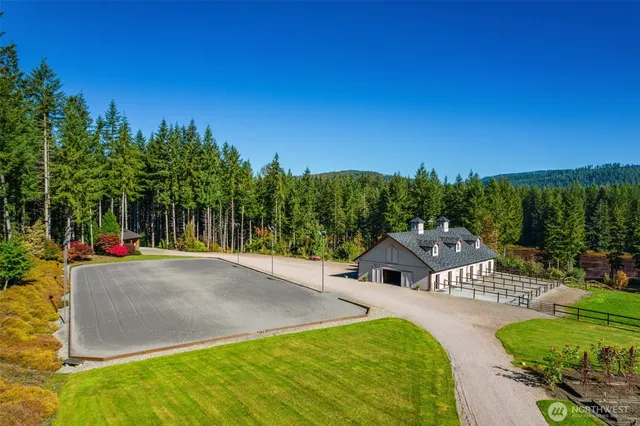 an outdoor sitting area with swimming pool and green space
