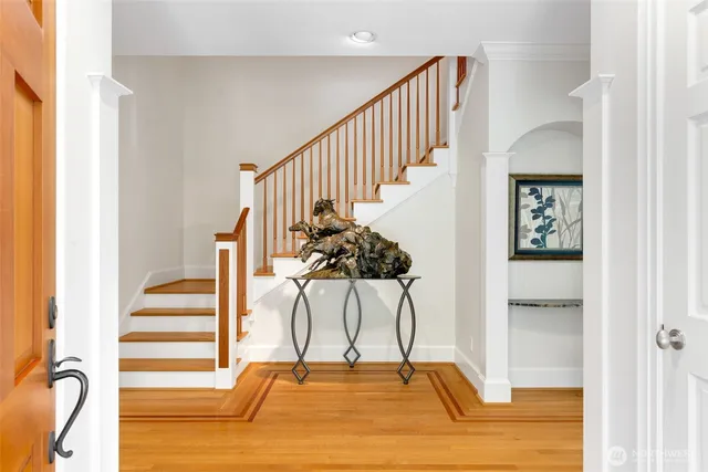 a view of entryway and hall with wooden floor