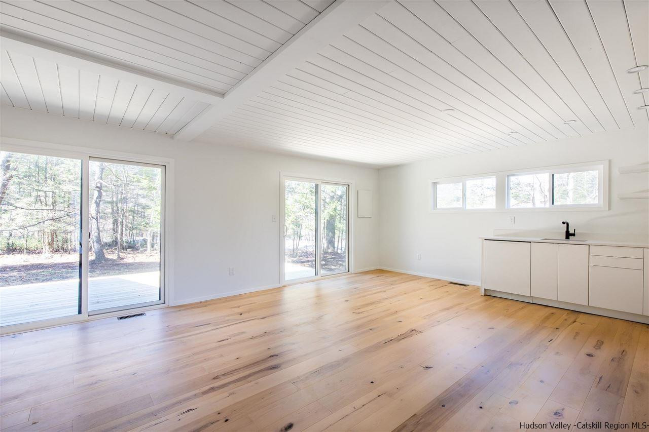 25 Upper Cherrytown Road Kerhonkson, NY 12446 - Photo 4 of 14 a view of an empty room with wooden floor and a window
