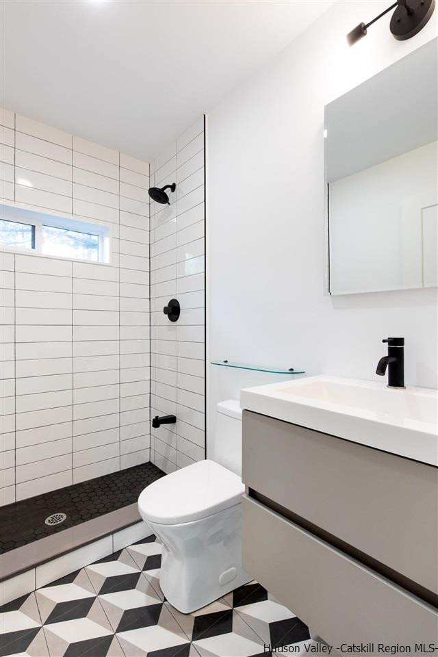 25 Upper Cherrytown Road Kerhonkson, NY 12446 - Photo 7 of 14 a bathroom with a sink a toilet and shower