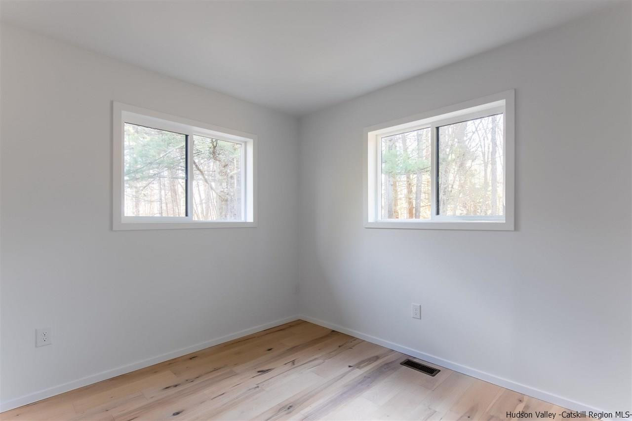 25 Upper Cherrytown Road Kerhonkson, NY 12446 - Photo 9 of 14 a view of a room with wooden floor and windows
