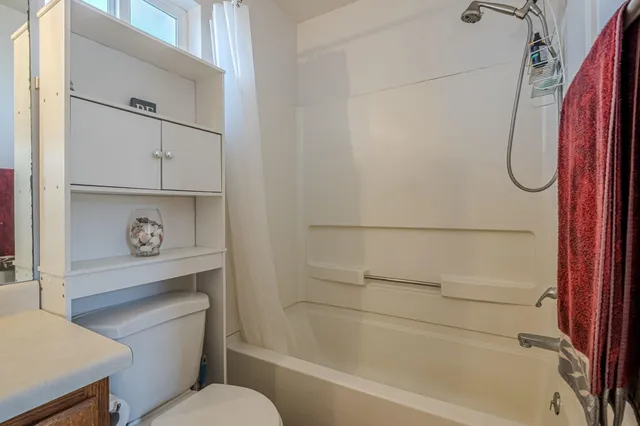 a bathroom with a shower a toilet and a sink
