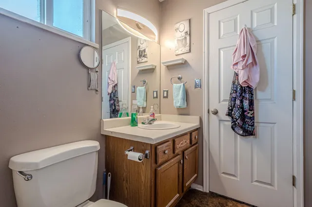 a bathroom with a sink and mirror with toilet