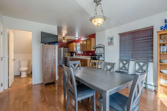 a view of a dining room with furniture window and wooden floor