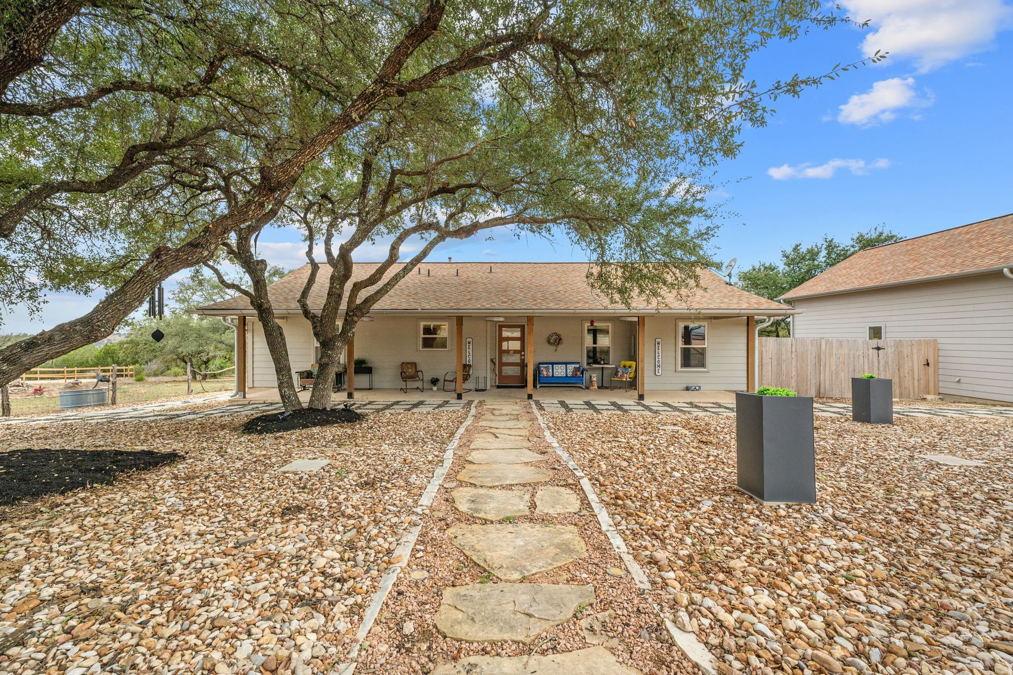 401 Ranchview Drive Johnson City, TX 78636 - Photo 2 of 40 Lovely canopy of Oak trees shade the front yard