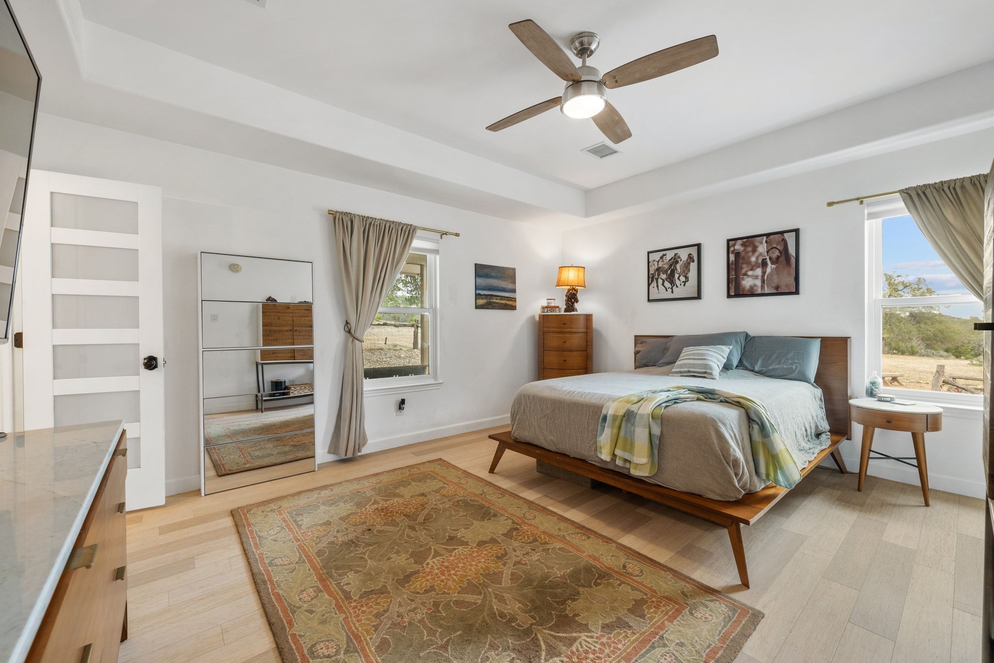 401 Ranchview Drive Johnson City, TX 78636 - Photo 21 of 40 Primary bedroom featuring light wood flooring and tray ceilings