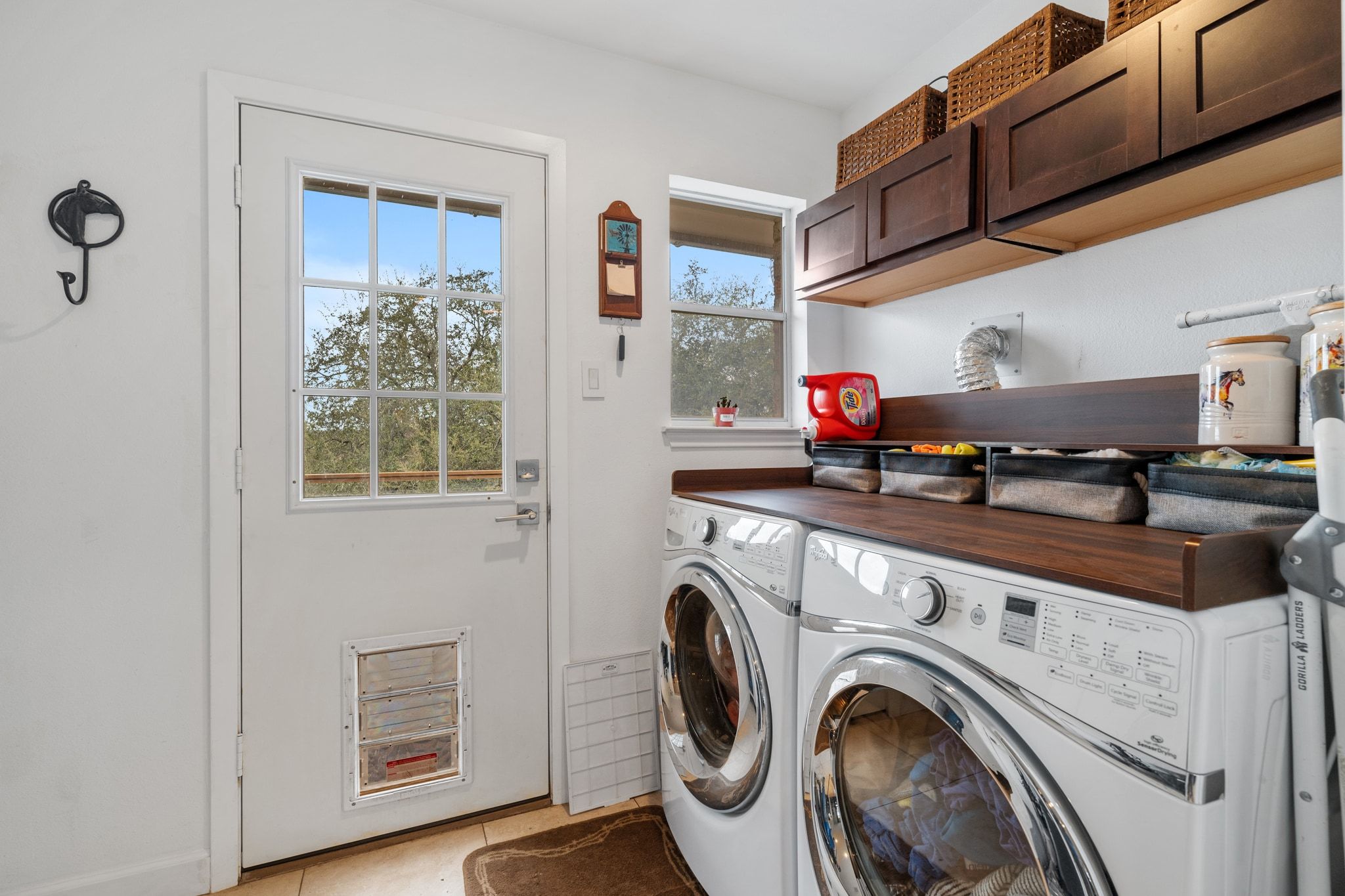 401 Ranchview Drive Johnson City, TX 78636 - Photo 27 of 40 Laundry room featuring plenty of natural light, , light tile patterned floors, and cabinet storage