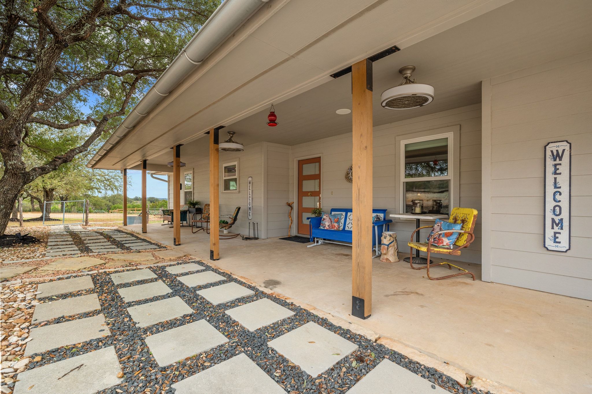 401 Ranchview Drive Johnson City, TX 78636 - Photo 7 of 40 Lovely front sitting porch w vintage fans to stay cool