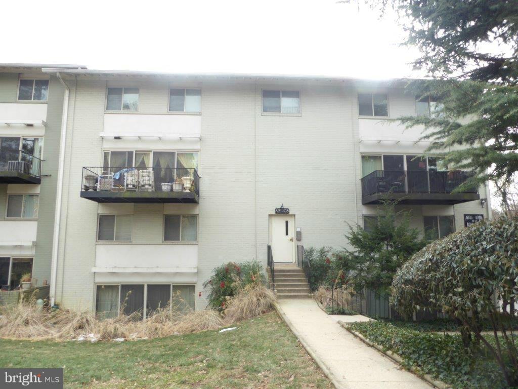a front view of a house with a garden and plants