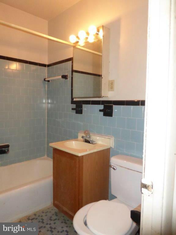 8706 Manchester Road, Unit 6 Silver Spring, MD 20901 - Photo 12 of 12 a bathroom with a sink a toilet and bathtub
