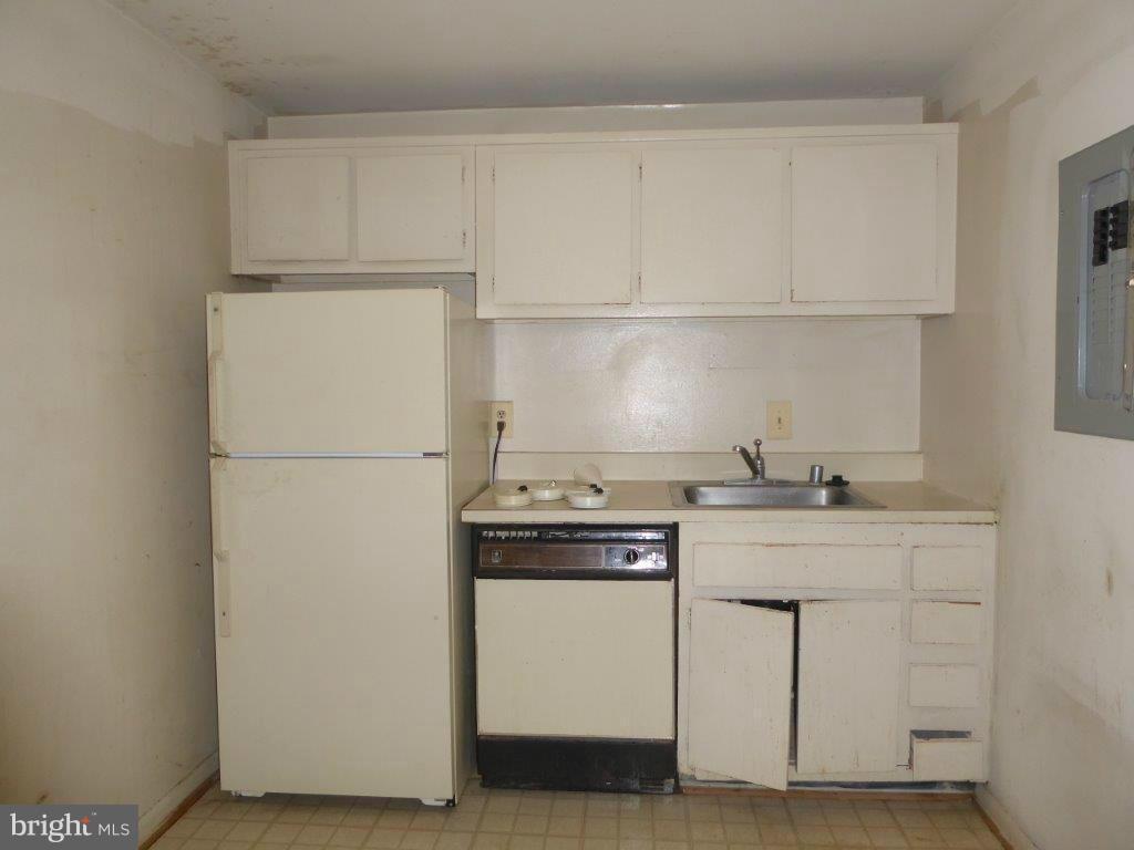 8706 Manchester Road, Unit 6 Silver Spring, MD 20901 - Photo 8 of 12 a kitchen with stainless steel appliances granite countertop white cabinets stove a sink and dishwasher