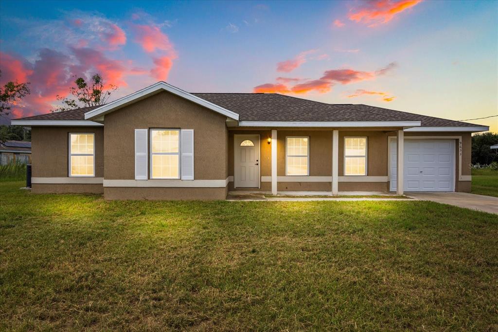 9633 Bahia Road Ocala, FL 34472 - Photo 1 of 1 a front view of a house with a yard