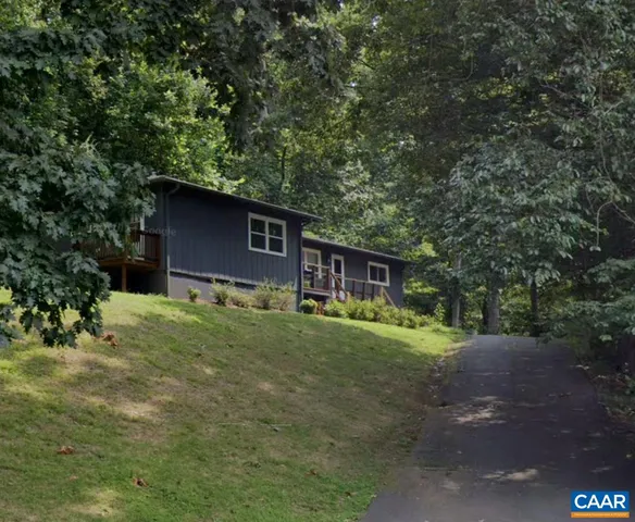 a backyard of a house with barbeque oven table and chairs