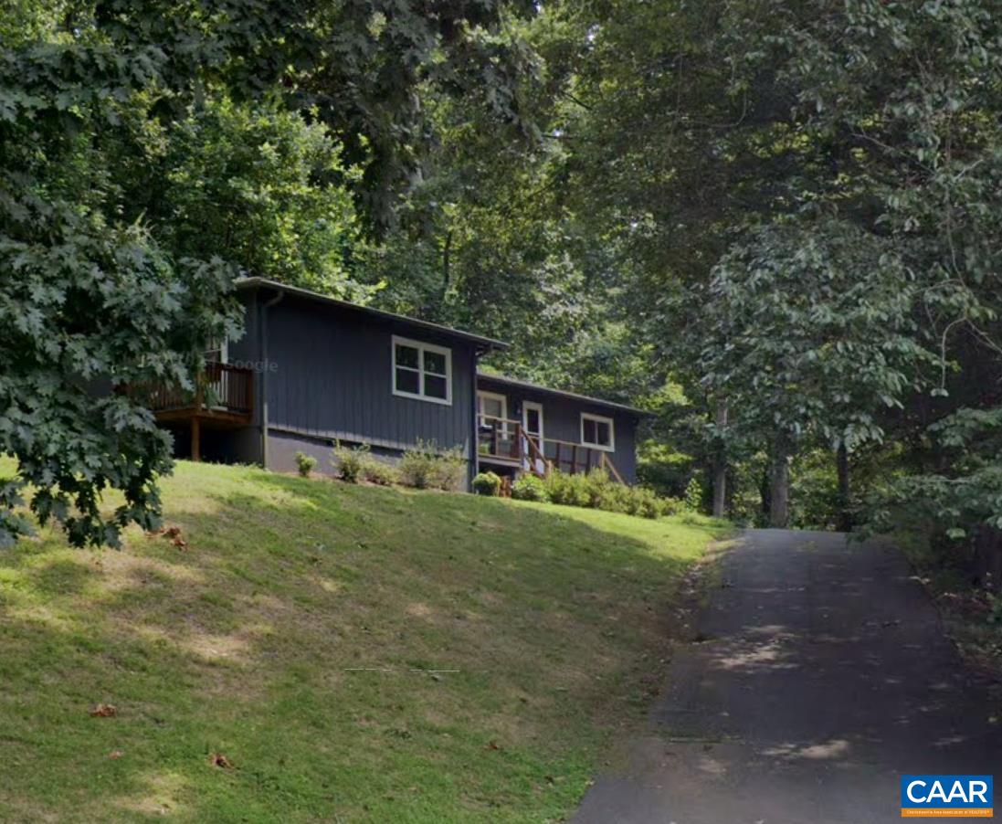 a backyard of a house with barbeque oven table and chairs
