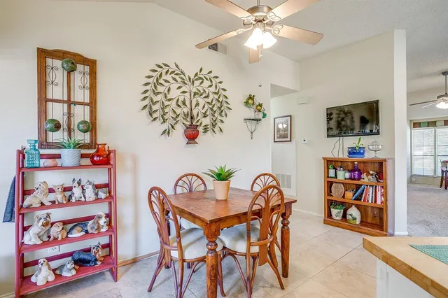 a dining room with furniture and a window