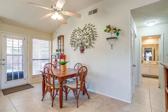 a dining room with furniture potted plants and wooden floor