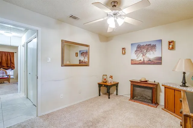 a view of a workspace with furniture and a ceiling fan