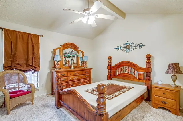 a bedroom with furniture and a chandelier