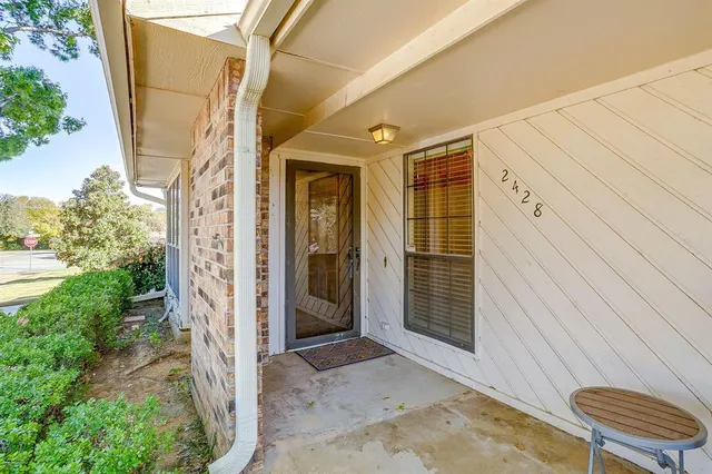 a view of a door and chair in the backyard
