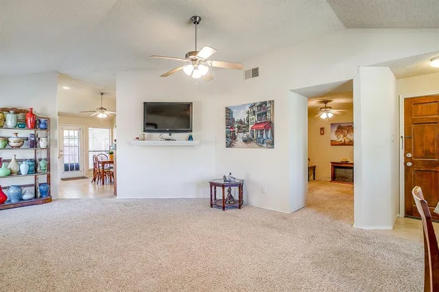 a view of a livingroom with furniture and a flat screen tv